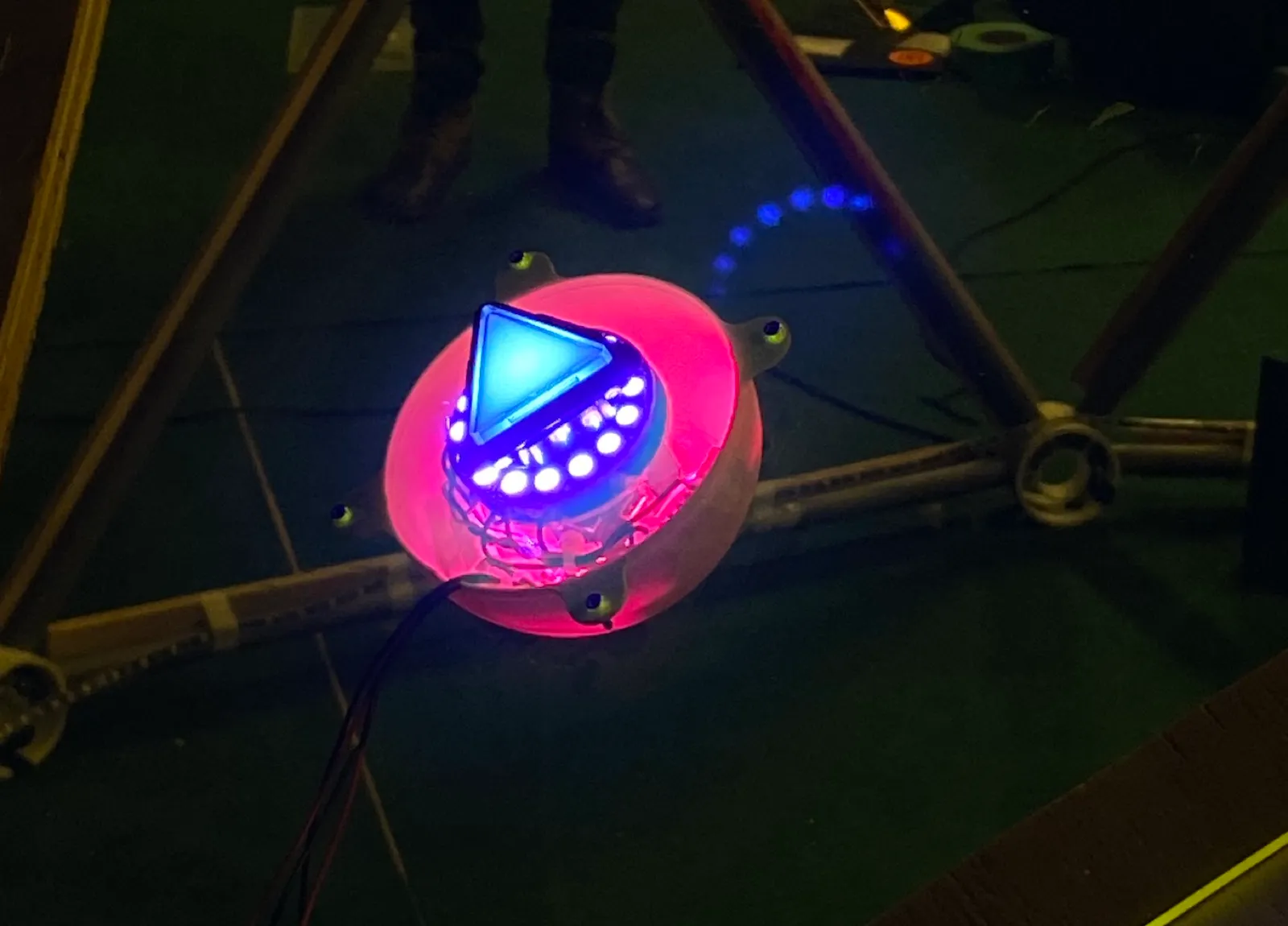 A lit button mounted into one of the play stations