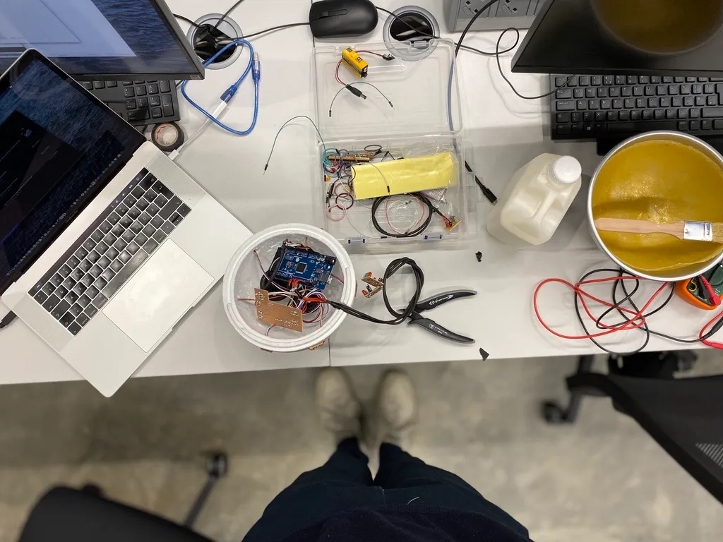 The circuitry laid out on a desk beside a laptop, mid-build