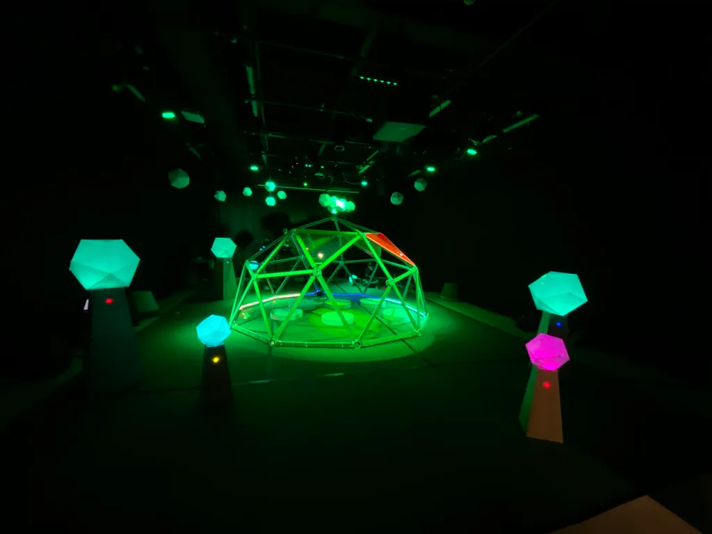 The dome in its final stages, glowing green among hexagonal lights
