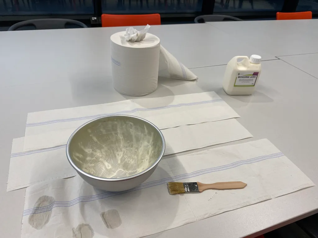 Silicone being brushed onto the inside of a mould