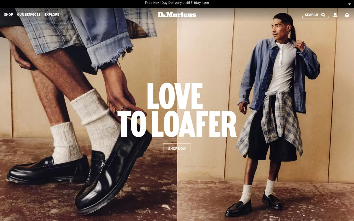 The Dr.Martens home page: two models in loafers and white socks against a warm backdrop, Love to Loafer set large in white across the middle under the Dr.Martens wordmark